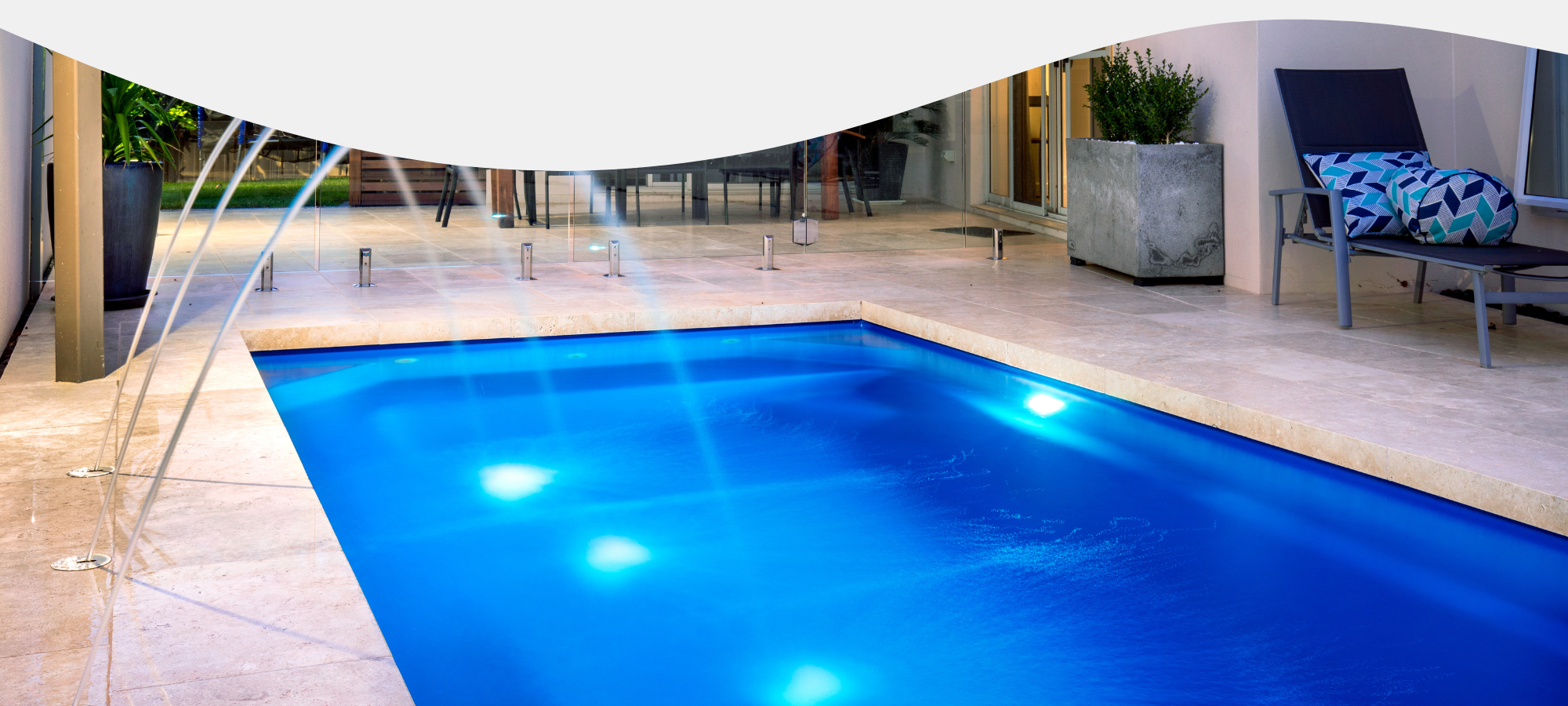 large inground pool with lighting features